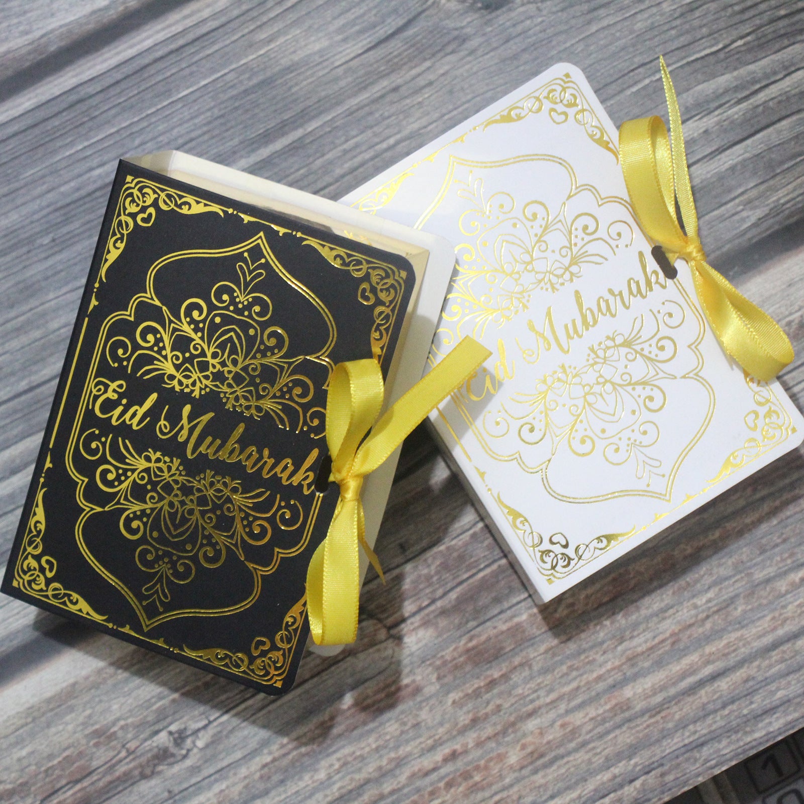 Golden Ramadan gift box featuring Quran elements and Ramadan ornament, beautifully arranged for special occasion celebration.