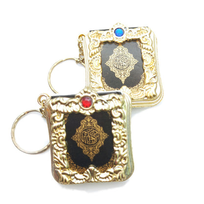 Golden Quran keychain pendant with hanging ring, featuring intricate Islamic design and Arabic calligraphy.