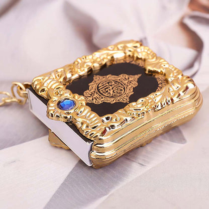 Golden Quran keychain pendant with hanging ring, featuring intricate design and Islamic calligraphy, ideal as a religious accessory.