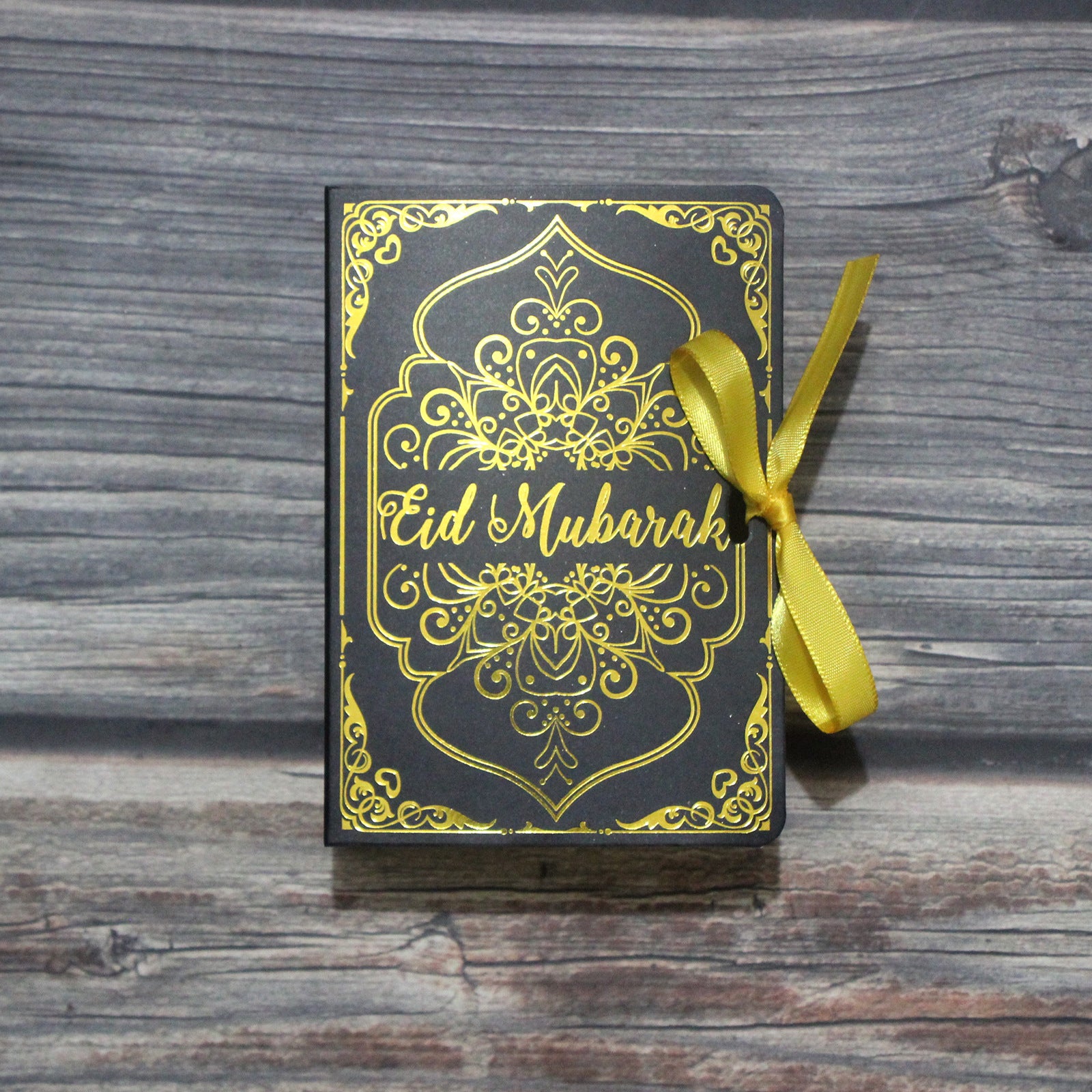 Golden Ramadan Gift Box featuring Quran elements and Ramadan ornament, elegantly designed for special occasion gifting.