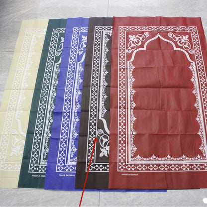 Golden prayer mat blanket with intricate Middle Eastern patterns, displayed folded on a neutral surface.