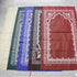 Golden prayer mat blanket with intricate Middle Eastern patterns, displayed folded on a neutral surface.
